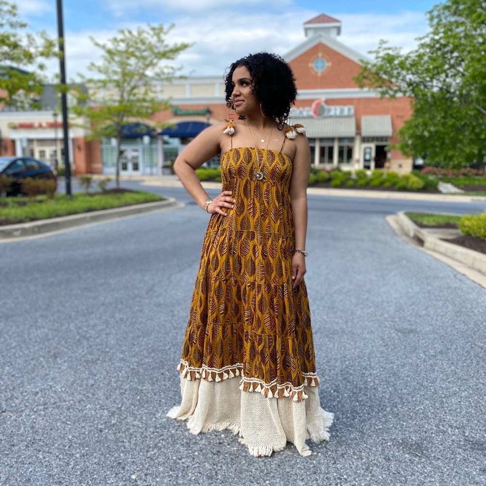 This maxi dress is cut at floor length with a smocked top and a tiered skirt.